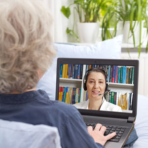 Woman on her laptop connecting with a psychologist